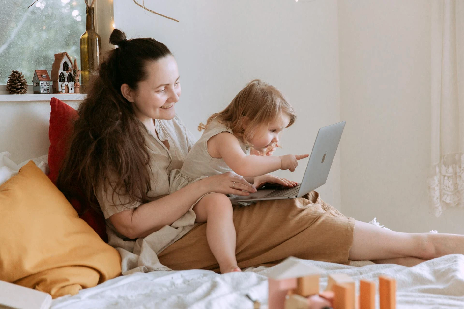 Woman and child looking at a laptop together at home