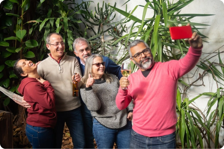 Group of friends taking a selfie together outdoors